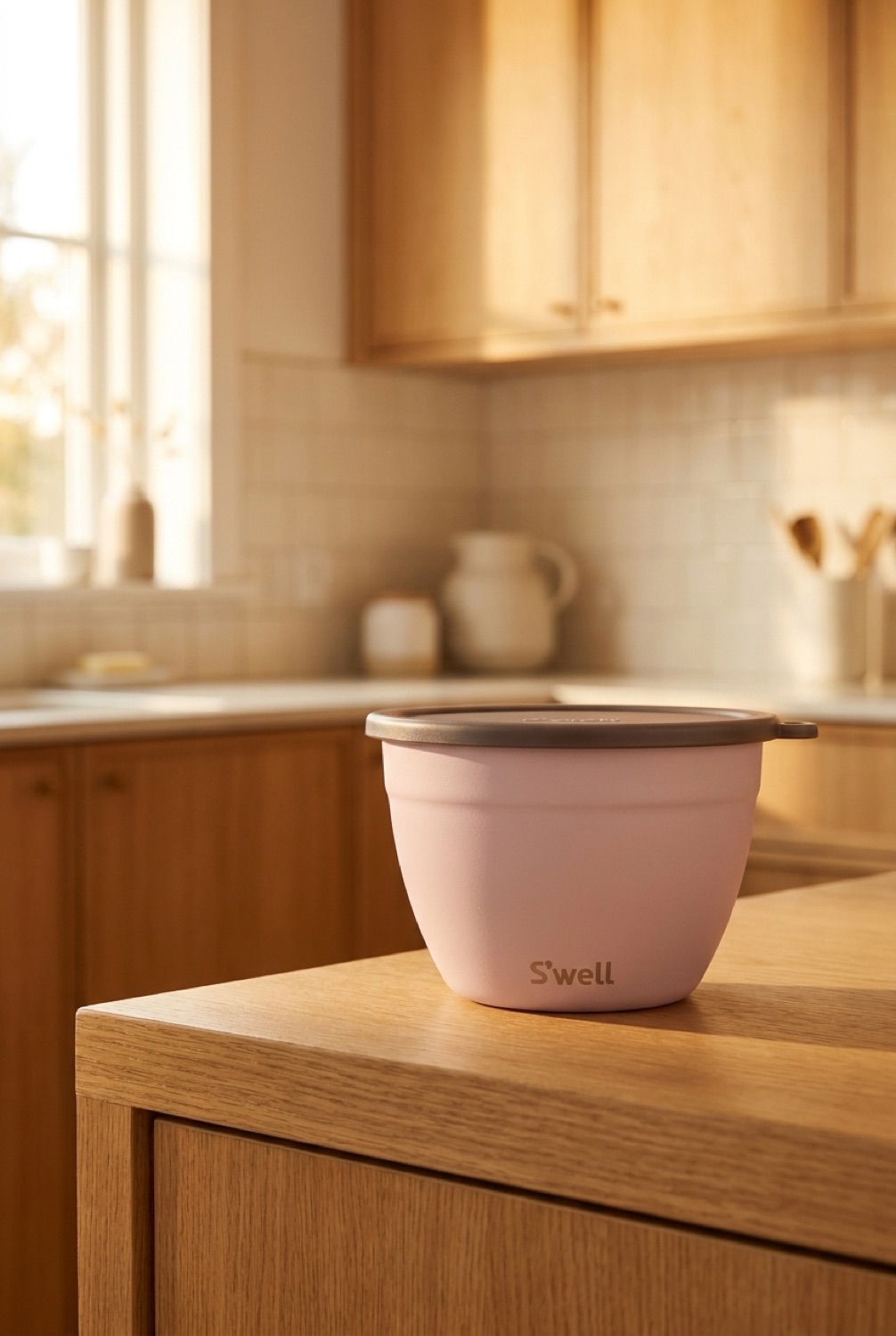insulated salad bowl on a warm oak kitchen counter in soft golden-hour light