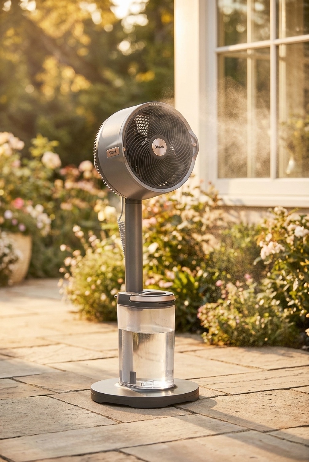 outdoor misting fan on a sunny garden patio in soft golden-hour light