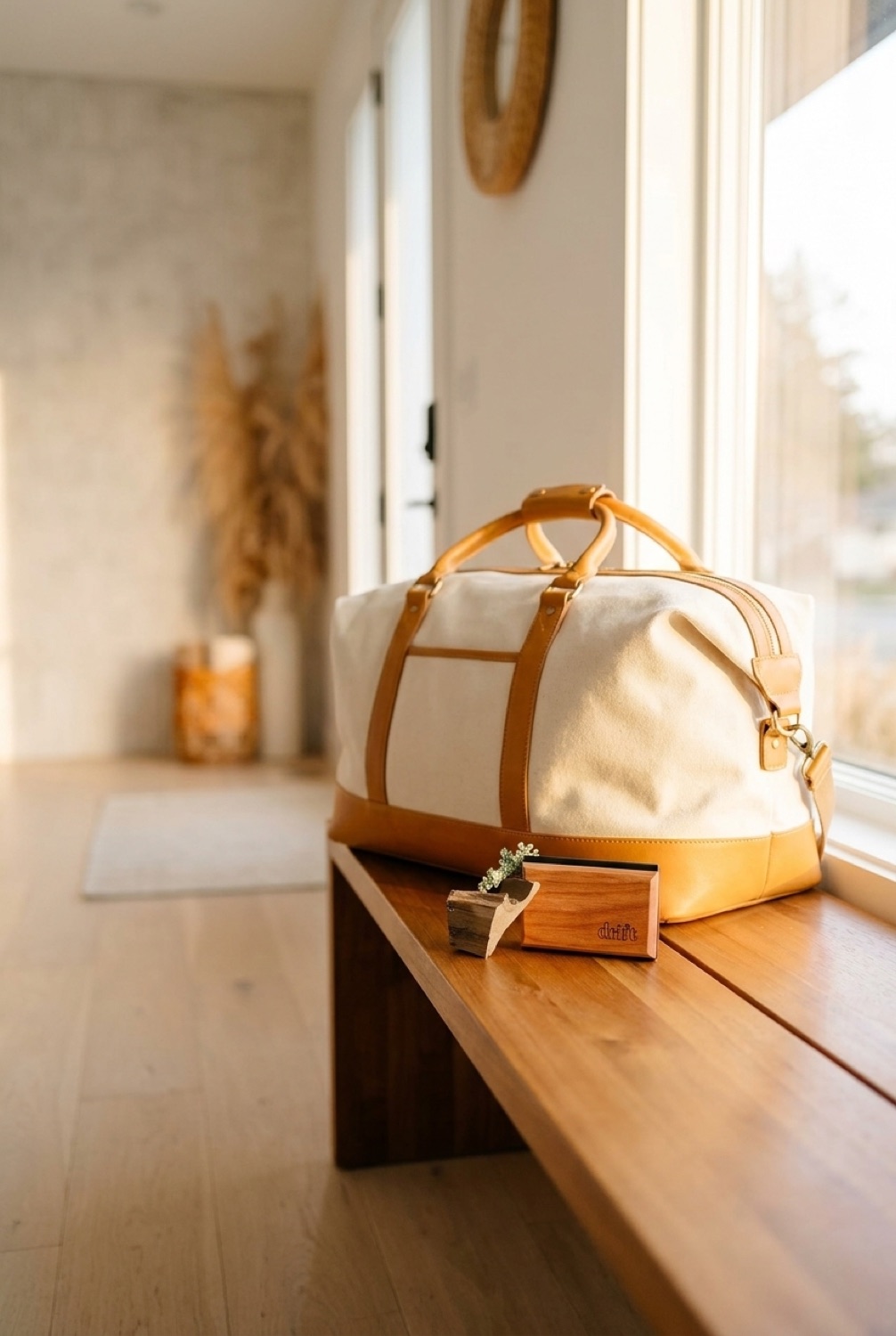 visor clip air freshener beside a packed bag in a bright entryway in soft golden-hour light